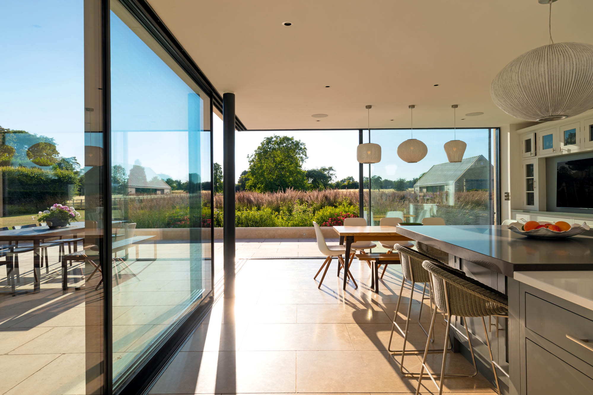 The garden seen from the striking glass kitchen extension. The garden at Park House, Harston, Cambridgeshire. ©Richard Bloom