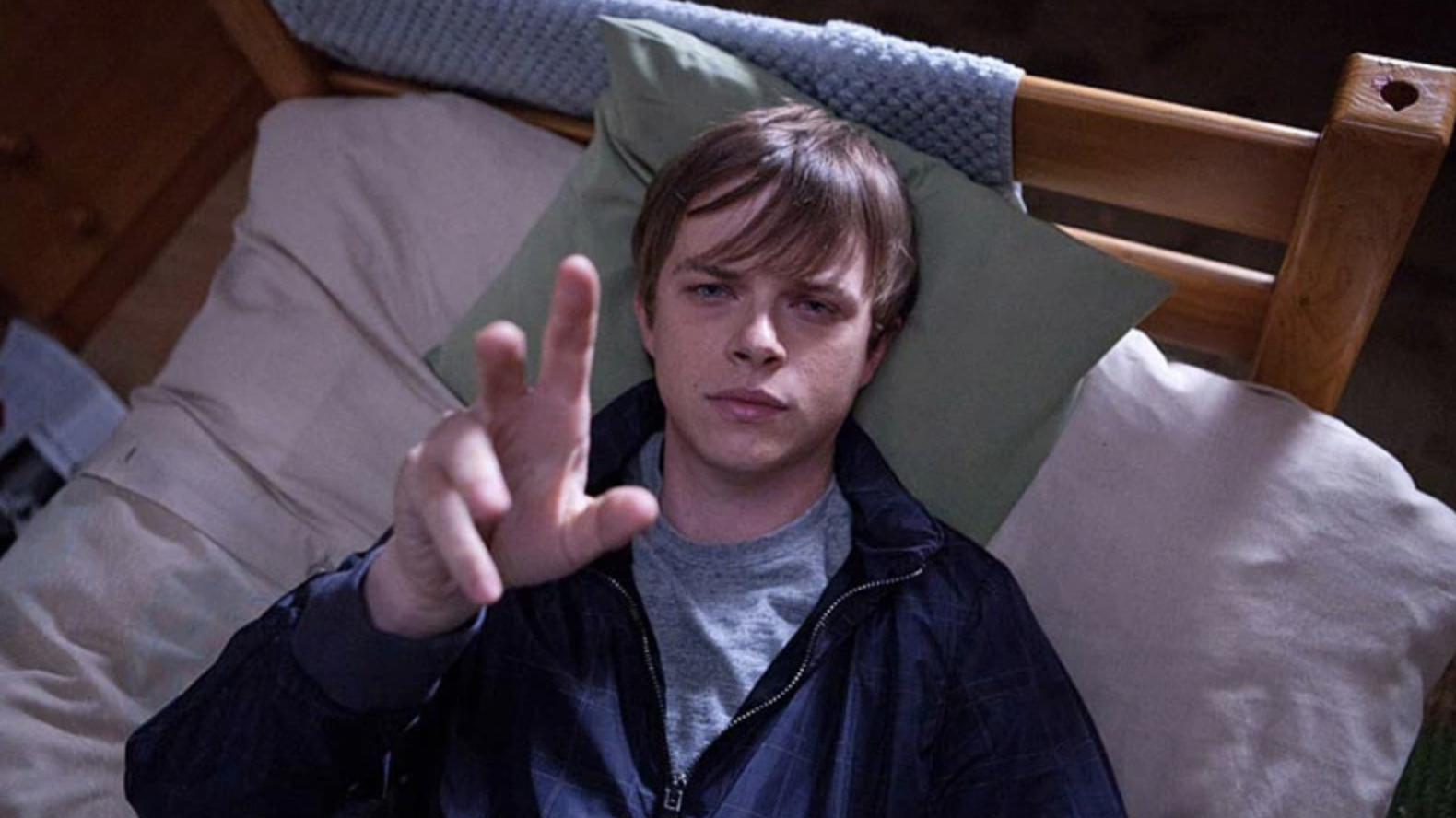 A still from the 2012 movie Chronicle in which one of the main characters, played by Dane DeHaan, reaches up to the camera.