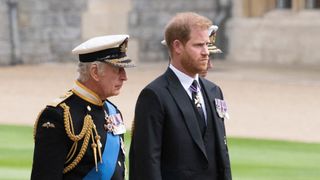 Britain's King Charles III (L) walks with his son Britain's Prince Harry, Duke of Sussex as they arrive at St George's Chapel inside Windsor Castle on September 19, 2022