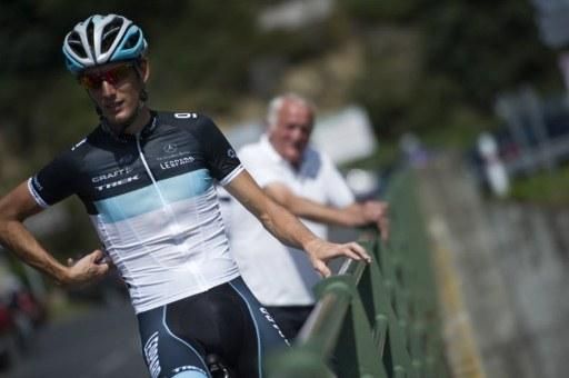 Luxembourg's Andy Schleck (L), flanked by his father, Johnny Schleck, poses at the Garabit viaduct in Anglards.
