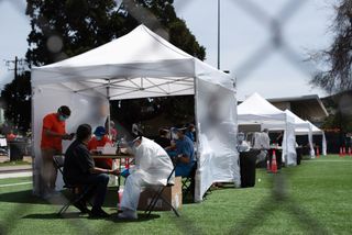 Researchers conduct COVID-19 testing in Garfield Park, San Francisco as part of a mass testing effort in part of the city's Mission District neighborhood.