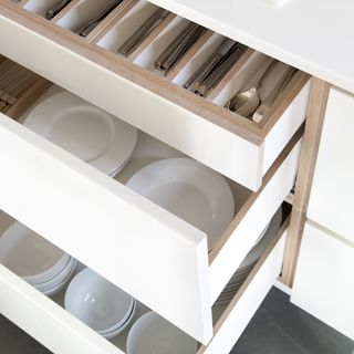 kitchen drawers with bowls plates and saucers