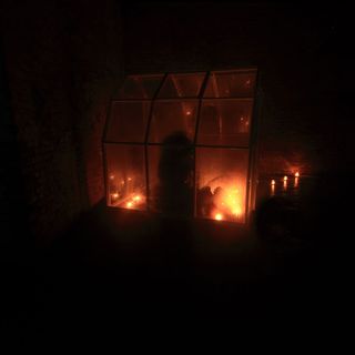 dark room with brick wall and candles