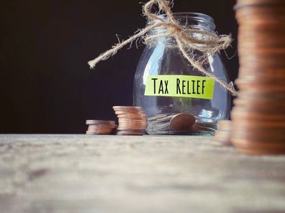 Pennies in jar labelled tax relief