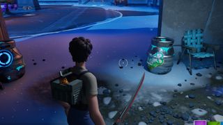 Fortnite - a player stands in the snow looking at a silver slurp barrel