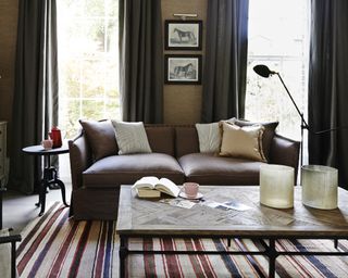 A living room with brown sofa idea with red and white striped rug