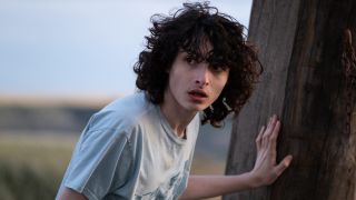 Finn Wolfhard stands shocked in a field in Ghostbusters: Afterlife.