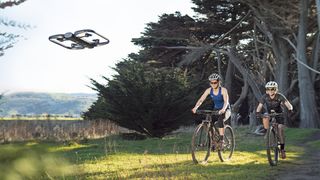 The Skydio R1 drone flying above two cyclists