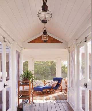 breezeway with vaulted ceiling leading to outdoor living room with lounger