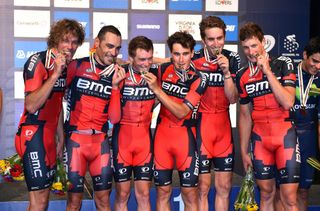 The successful BMC team kiss their medals on the podium