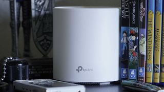 TP-Link Deco X60 near Blu-Ray cases