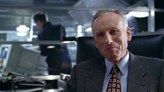 James Rebhorn smiling, wearing a suit in The Game