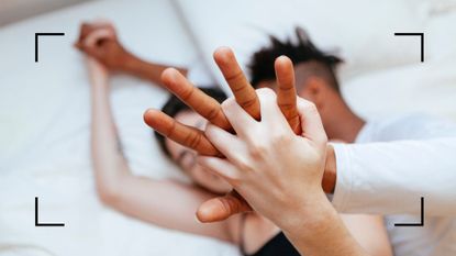 couple holding hands in bed 