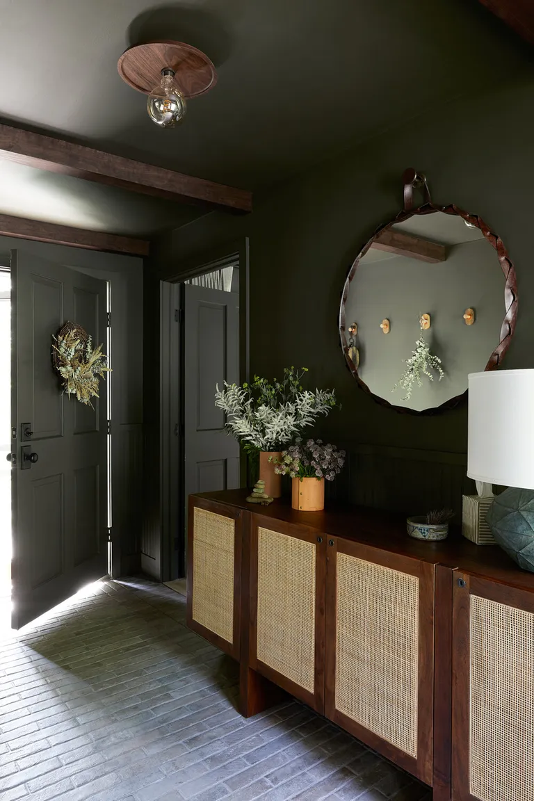 A small entryway painted in a dark color