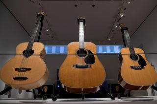 Three acoustic guitars owned by David Gilmour and sold as part of The David Gilmour Guitar Collection are displayed during a press preview at Christie's on June 14, 2019 in New York City. (from left) 1978 Zemaitis Acoustic Fretless Bass; 1969 Martin D-35; and 1971 Martin D12-28