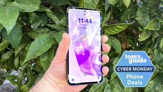 Samsung Galaxy A35 held in hand in front of tree with cyber monday badge