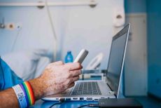 image of arm of hospital patient with rainbow wristband