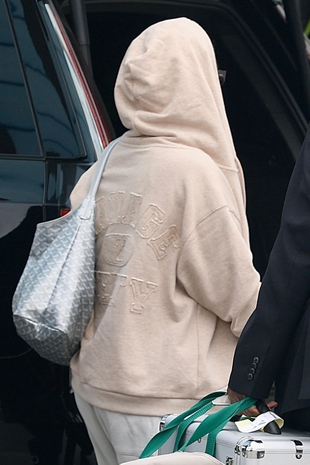 Rihanna wears a Goyard silver bag