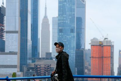 A woman wearing a mask walks in New Jersey.