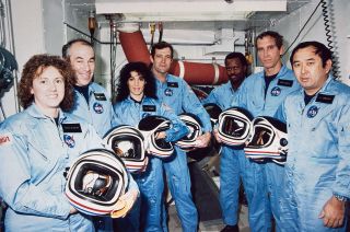 NASA's STS-51L crew members pose for a photograph during a break in training for their January 1986 launch. From left to right: Christa McAuliffe, Greg Jarvis, Judy Resnik, Dick Scobee, Ronald McNair, Mike Smith and Ellison Onizuka.