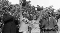 Tour de France winners Frenchman Laurent Fignon and Marianne Martin of the United States smile on the podium on July 22, 1984 in Paris, surrounded by Paris Mayor Jacques Chirac (L) and Prime Minister Laurent Fabius. Fignon reveals, on June 11, 2009 in Paris during the recording of a TV show released on June 14, that he suffers from and advanced stage cancer, but that there are no links with doping products. Fignon won the Tour de France in 1983 and 1984. AFP PHOTO FILES (Photo by FILES / AFP) (Photo by -/FILES/AFP via Getty Images)