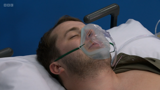 Ben Mitchell in hospital with an oxygen mask on