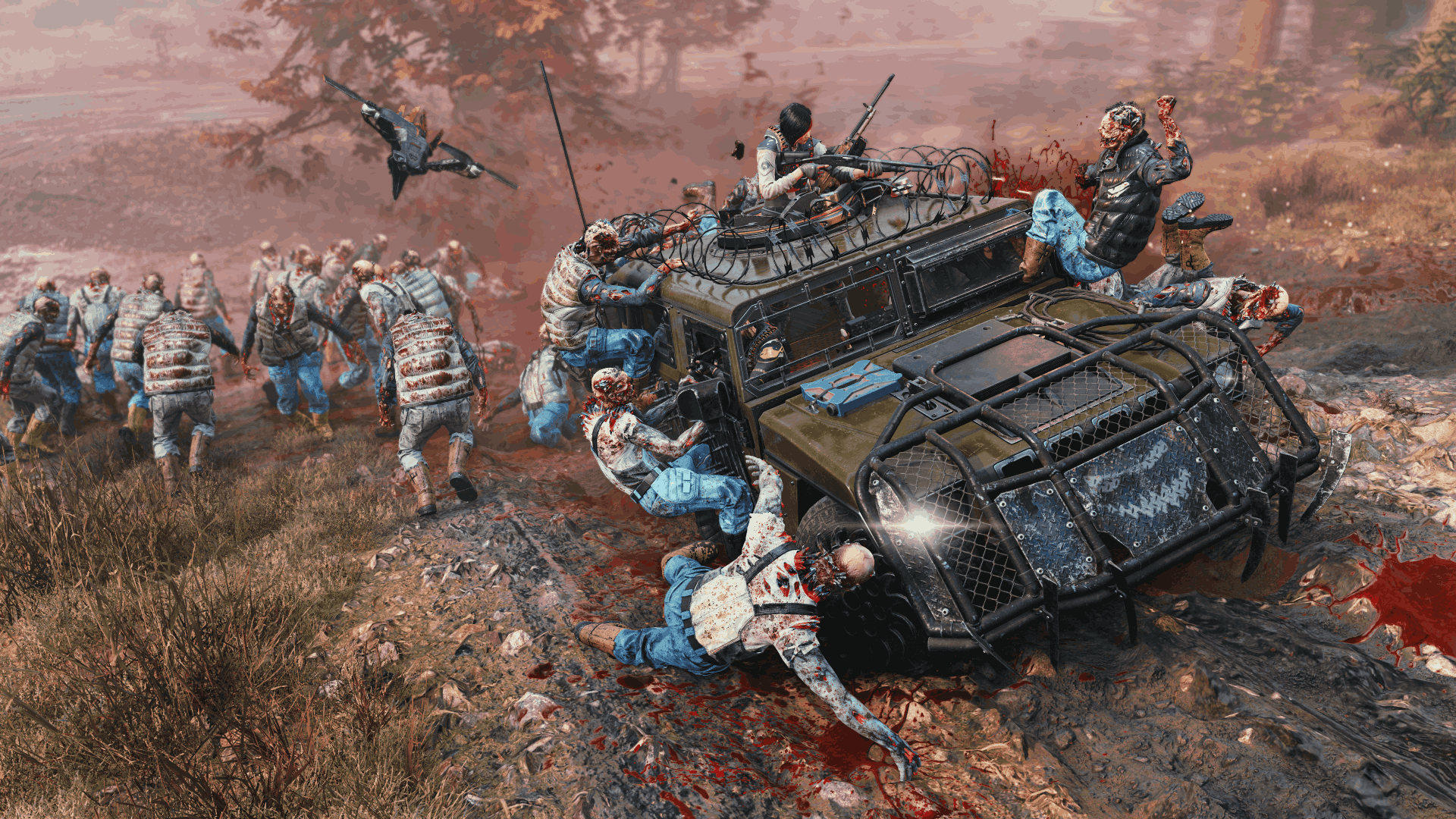 A promotional screenshot of John Carpenter's Toxic Commando that shows a group of players driving an armored vehicle through some sludge zombies in a muddy environment.