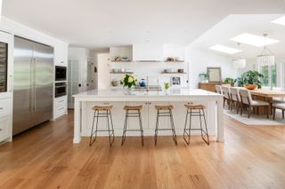 Kitchen with white cabinets, large island and dining table