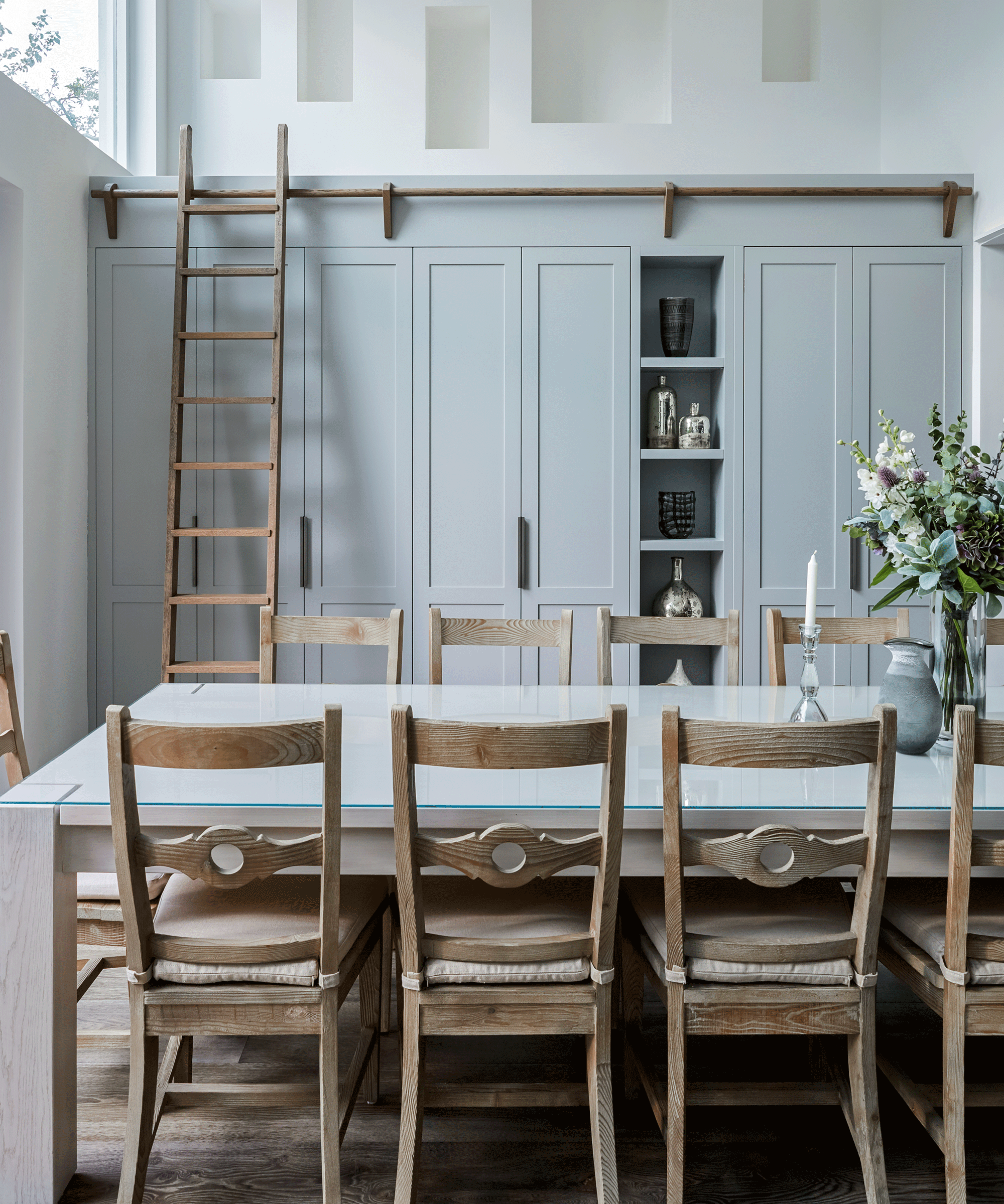 Blue floor to ceiling kitchen cabinets with ladder