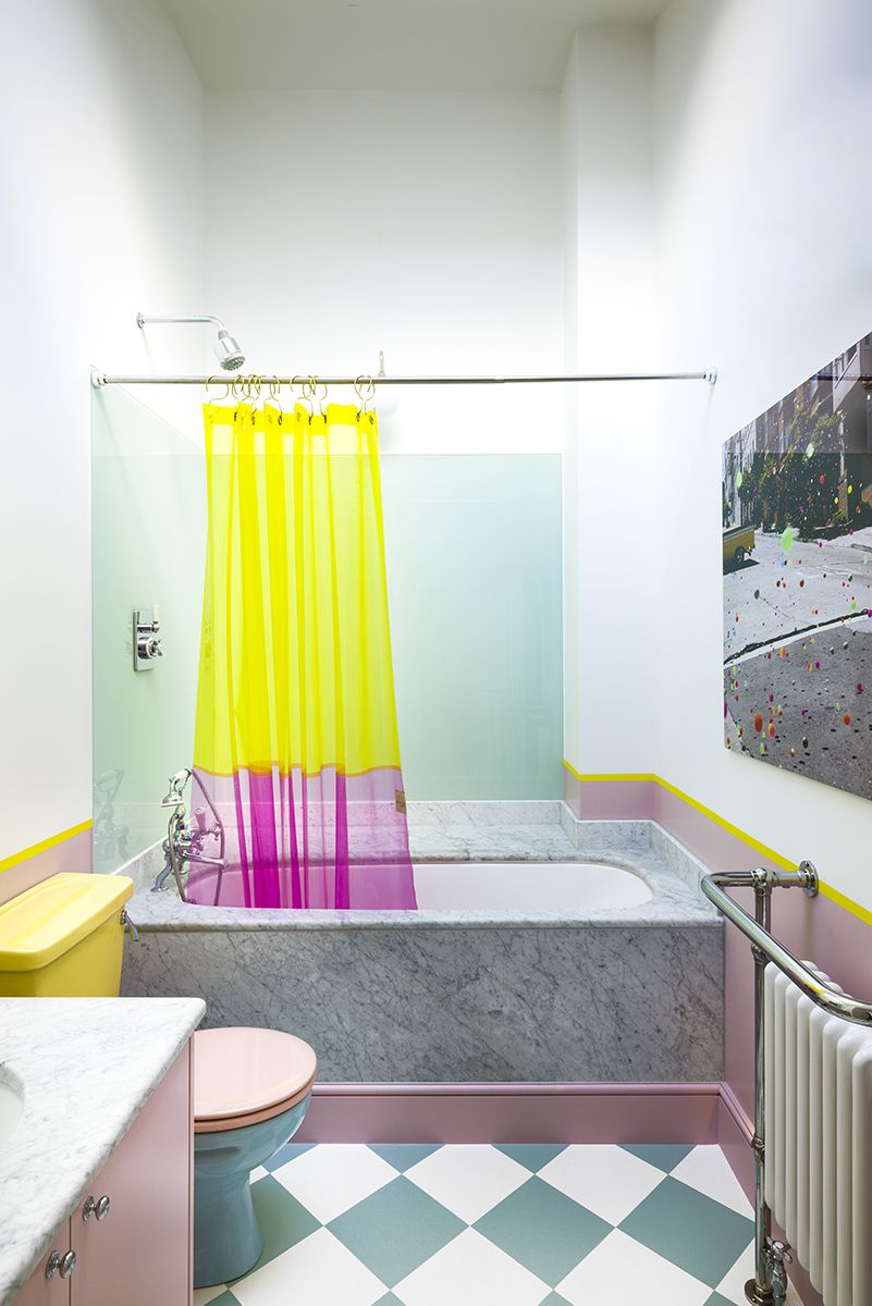 Bathroom with bath and shower over and shower curtain and checkered tile floor