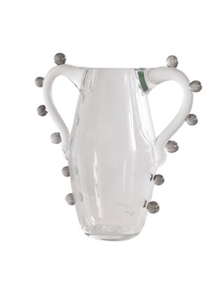 A glass vase features a two-arm amphora-inspired design with round spheres outlining its silhouette.