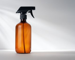 Amber glass bottle of essential oil cleaning spray