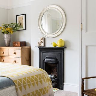 bedroom with white wall and mirror