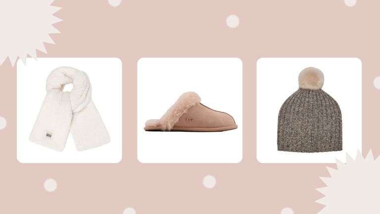 three of the products in the UGG Cyber Monday sales—the UGG Sherpa Oversized Scarf, UGG Scuffette II Metal Logo Slippers In Dusty Pink and UGG Pippa Rib Knit Pom Hat—on a pale pink background with white festive decoration