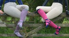 Two riders wearing the Woof Wear Long Bamboo Waffle Riding Sock