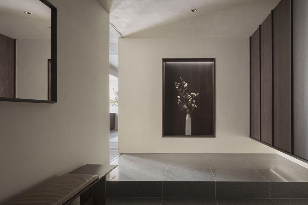 Entrance hall of Karimoku Case Study house with wood panelling and a flower vase