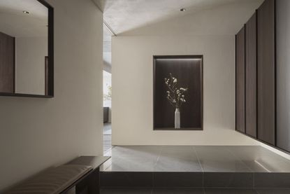 Entrance hall of Karimoku Case Study house with wood panelling and a flower vase