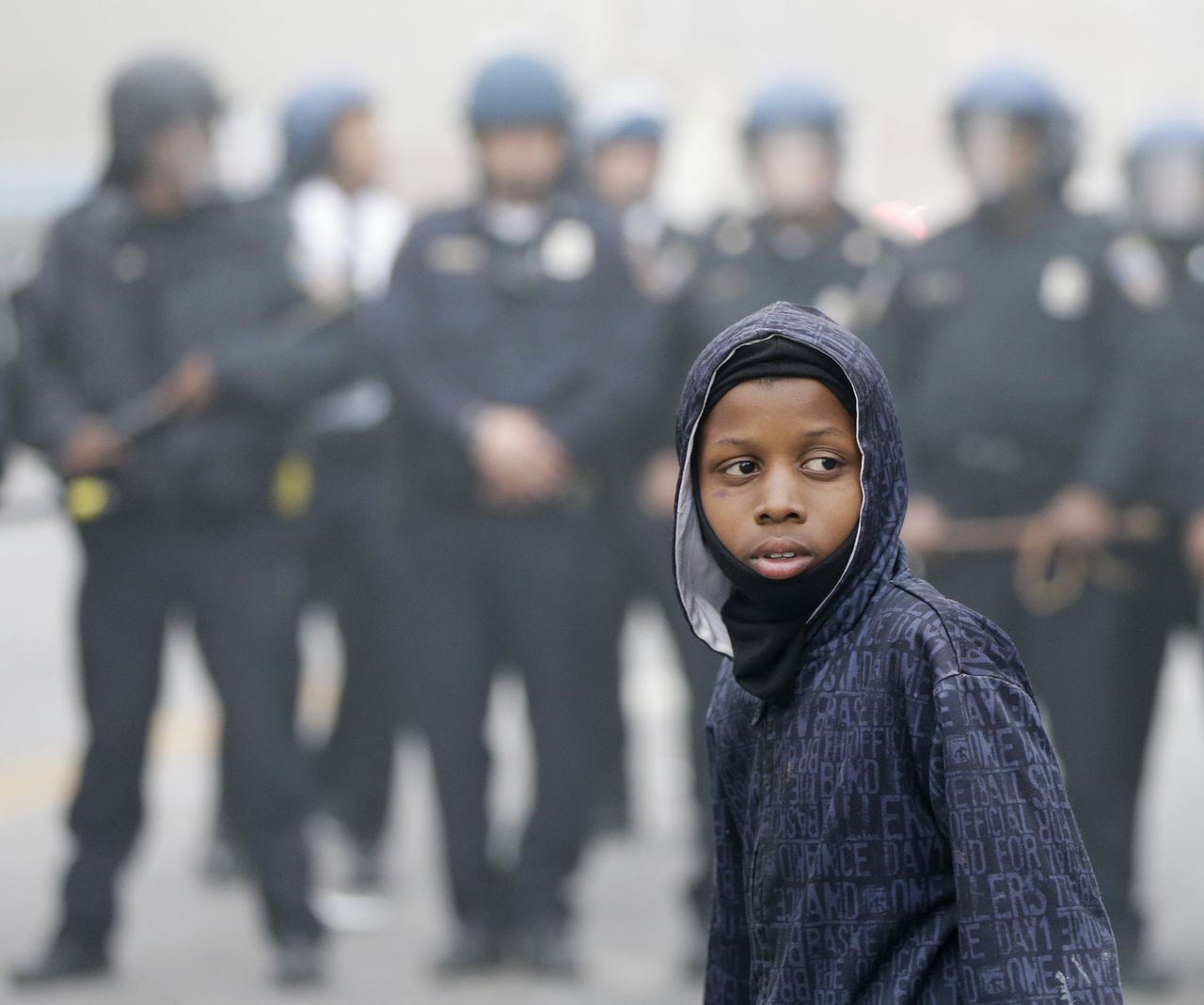 Police push back a protester in Baltimore.