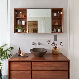 Wooden vanity in white bathroom with wooden look basin