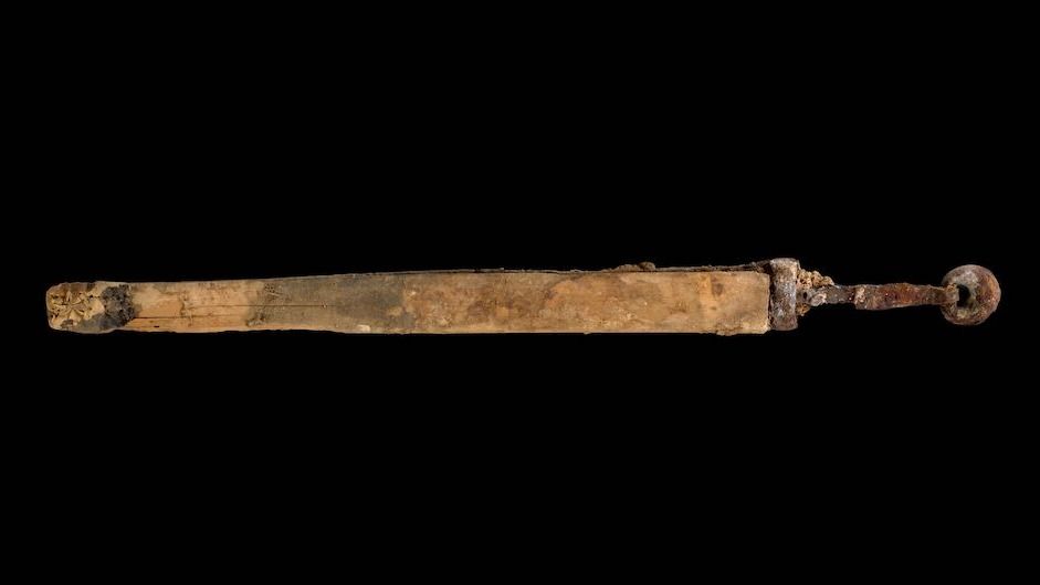 A 1,600-year-old Roman sword photographed inside a studio with a black background. 