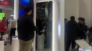 A man standing in front of the Withings Omnia smart mirror, on the CES 2025 show floor