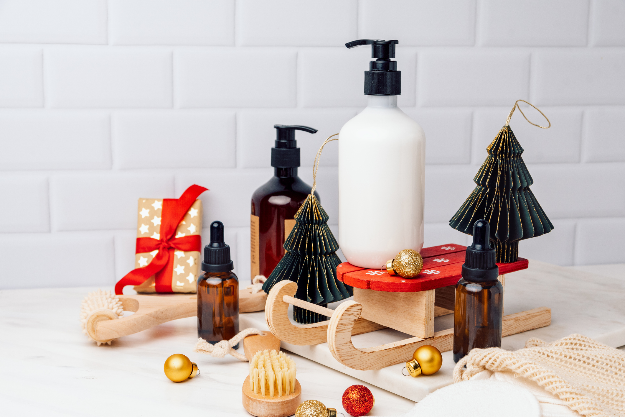 A christmas scene with brown glass bottles of beauty products.