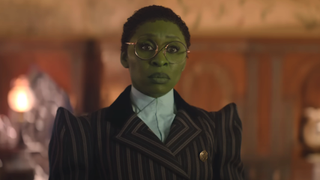 Cynthia Erivo as Elphaba in Wicked wearing glasses and a pinstripe suit