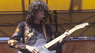 Jimmy Page performing on stage at Oakland Coliseum 1977