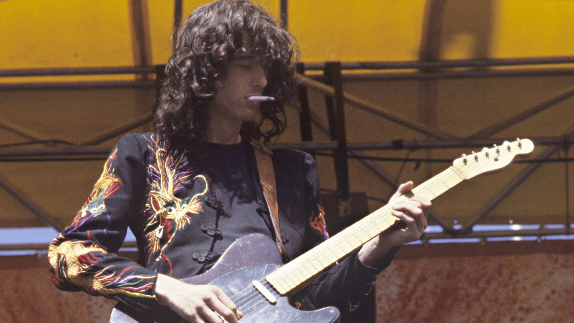 Jimmy Page performing on stage at Oakland Coliseum 1977
