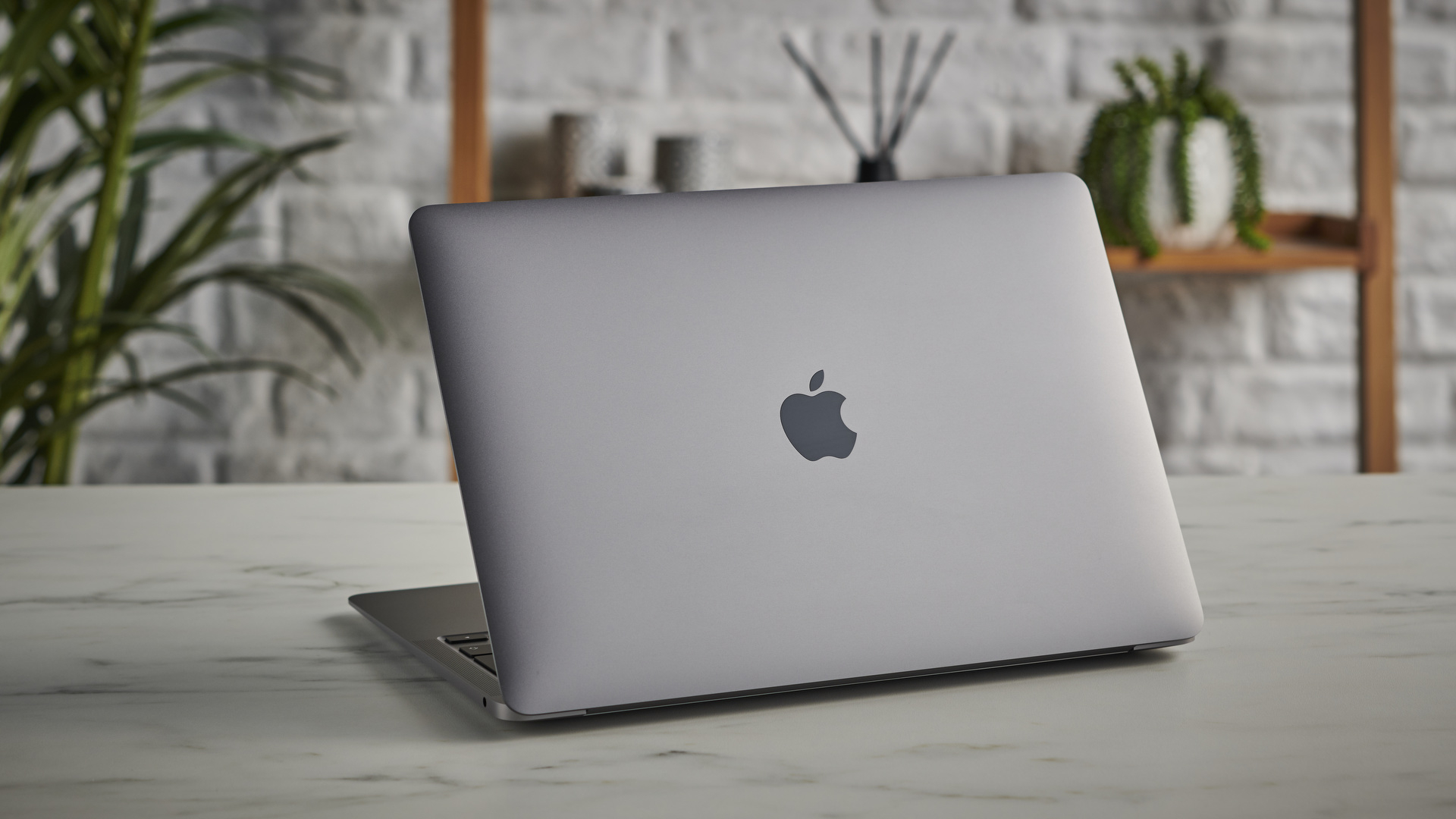 MacBook Air M1 on a table with the lid and the Apple logo