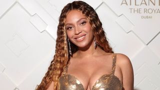 beyonce headshot on the red carpet with long curly caramel hair