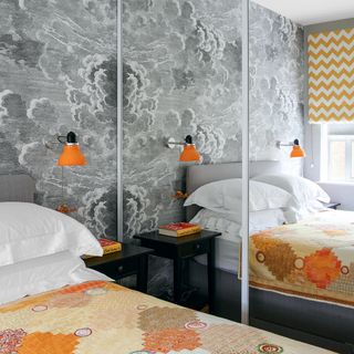 s and an orange wall light and cloud patterned wallpaper