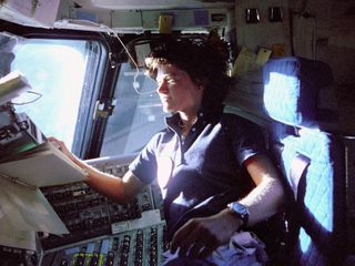 The first U.S. woman in space, Sally Ride, monitors control panels from the pilot's chair on the Flight Deck of the STS-7 mission. 