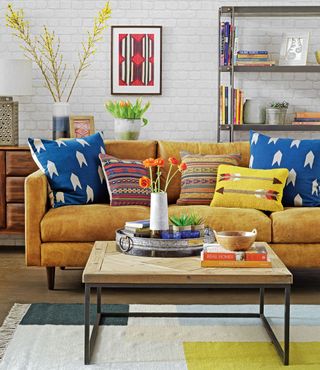 living room with mustard yellow sofa and table
